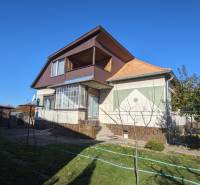 A family house in Vráble with an attic, a small terrace, and a garden with fruit trees.
