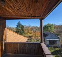 A balcony of a family house in Vráble with a view of the garden and the roof of the shelter.