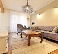 Living room in a 3-room apartment with a wood-patterned floor and stylish furniture.