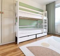 A children's room in a three-room apartment with a bunk bed and a floor with a wooden decor.
