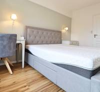 Bedroom in a 3-room apartment with a comfortable bed and a floor with a wooden decor.