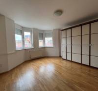 A spacious room with wooden flooring and a built-in wardrobe in a 3-room apartment.