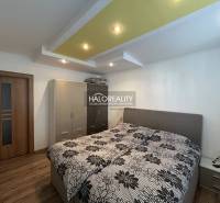 Bedroom with a bed and storage space in a 2-room apartment, floor with wood decor.