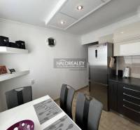 A kitchen in a 2-room apartment with a dining table and modern equipment.