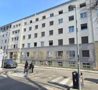 Building on Bezručova Street in Bratislava - Old Town, facade with windows and pedestrians.