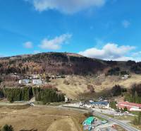 Hilly landscape with forests and buildings in Donovaly, Spiežovec area, near 3-room apartments.