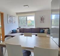 Dining room in a 3-room apartment with a view of the living room and children's room.