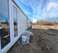 Agricultural and forest land in Radvaň nad Dunajom with a mobile home on the edge of the property.