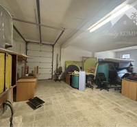 Commercial premises with storage space, office furniture, and industrial doors.