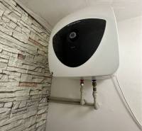 Heating unit in a studio apartment with stone cladding on the wall.