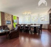 Offices with wood-patterned flooring, leather chairs, and large windows.