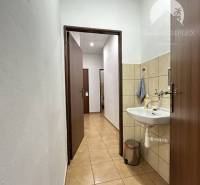 Offices with a sink and tiled floor, a cozy space for work.