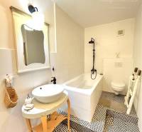 A stylish bathroom in a 3-room apartment with a unique floor and a shower tray.