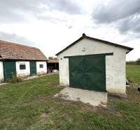 A garden and two buildings at a family house in Komárno with a grassy area.