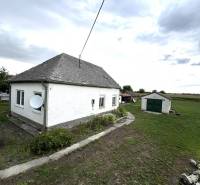 A family house in Komárno with an adjacent lawn and a satellite dish on the facade.