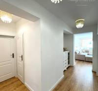 Interior of a family house with a wooden decor floor and chandeliers.