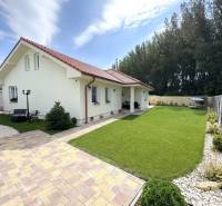 A family house in Dunajská Streda with a lawn and a paved walkway.