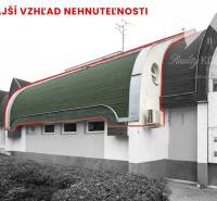 Exterior of commercial premises in Komárno with a curved roof and air conditioning.