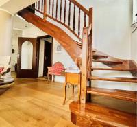 Wooden staircase with a wood-patterned floor in a family house.