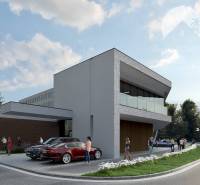 A modern building with glass railings, cars, and people on a residential property.