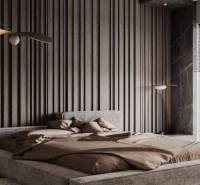 Stylish bedroom with an upholstered bed, wooden paneling in a 2-room apartment.