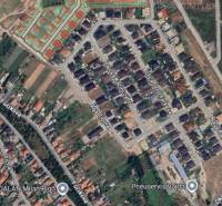 Aerial view of residential land in the town of Veľký Meder with development.