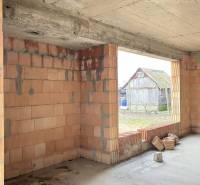 Unfinished interior of a family house with raw brick walls in Zlatná na Ostrove.