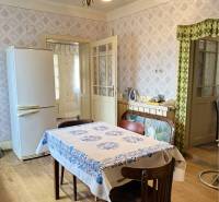 Interior of a family house with a wooden decor floor and a dining table.