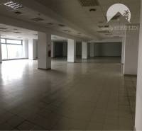 Spacious commercial spaces with large windows and light tiles.