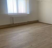 A room with walls, a window, and a wooden decor floor in warehouses and halls.