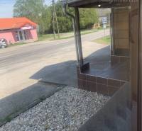 Exterior in Chotín on Hlavná Street with warehouses and halls and gravel decor.