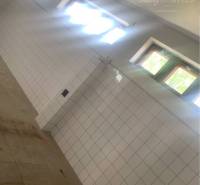 Interior of a warehouse with a tiled wall and windows, Warehouses and halls.