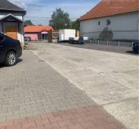 Asphalt road and buildings on Hlavná Street in Chotín, area Warehouses and Halls.
