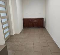 Commercial premises with tiles, simple walls, and glass doors.