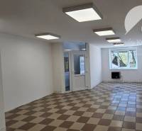 Commercial premises with ceramic flooring, white walls, and ceiling lights.
