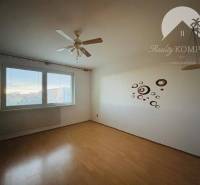 A room in a 3-room apartment with wall decorations and a view of the city.