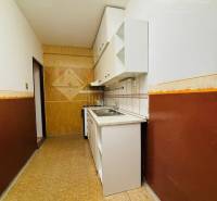 Hallway in a 3-room apartment, light walls, wooden paneling, built-in cabinets.