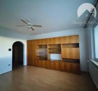 A room in a 3-bedroom apartment with a bright interior and a door leading to the hallway.