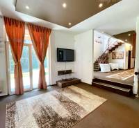 Elegant interior of a family house with a decorative carpet and staircase.
