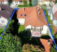 A family house in Dunajská Streda with a red roof and an enclosed garden.