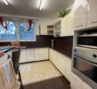 A kitchen in a family house with a kitchen unit and a bar counter, interior in white color.