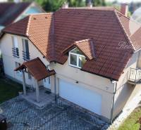 A family house in Dunajská Streda with a red roof, a small balcony, and a garage.