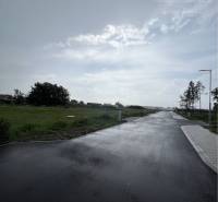 Asphalt road between residential plots on Bučuháza Street in Šamorín.