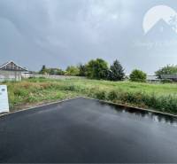 A residential plot in Šamorín on Bučuháza with an asphalt access road.
