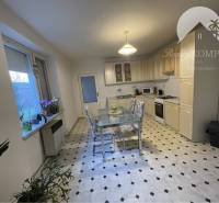 The kitchen in a family house with a dining table, window, and kitchen unit.