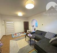 Living room in a family house with a wooden decor floor and a comfortable sofa.