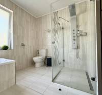 A bathroom in a family house with a spacious shower and modern equipment.