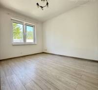 A spacious room in a family house with a wooden decor floor.