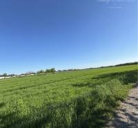 Plots - housing in Kostolné Kračany with open countryside and blue skies.