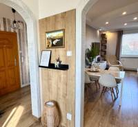 Interior of a 4-room apartment with wooden floors and arched doorways.